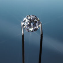 Tweezers holding diamond, close-up